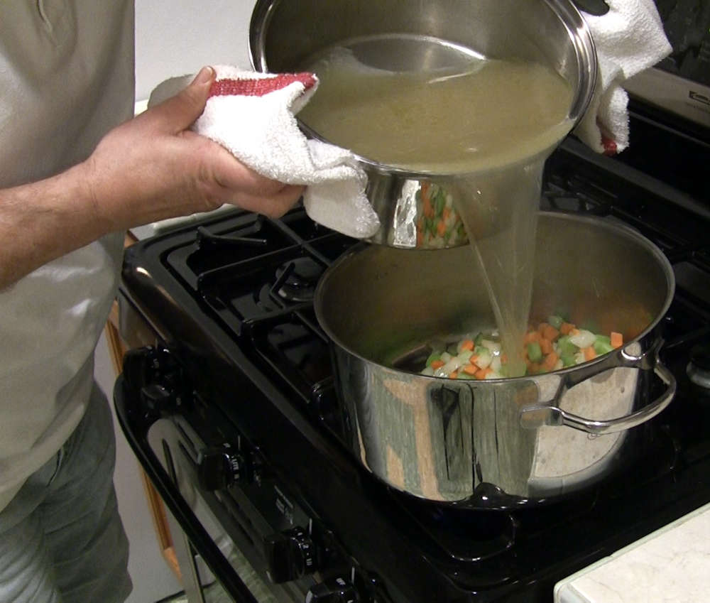 Pouring Chicken Broth Over Saute'd Mirepoix