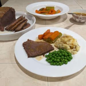 Dish of Pot Roast With Celery, Carrots, Mashed Potato and Peas