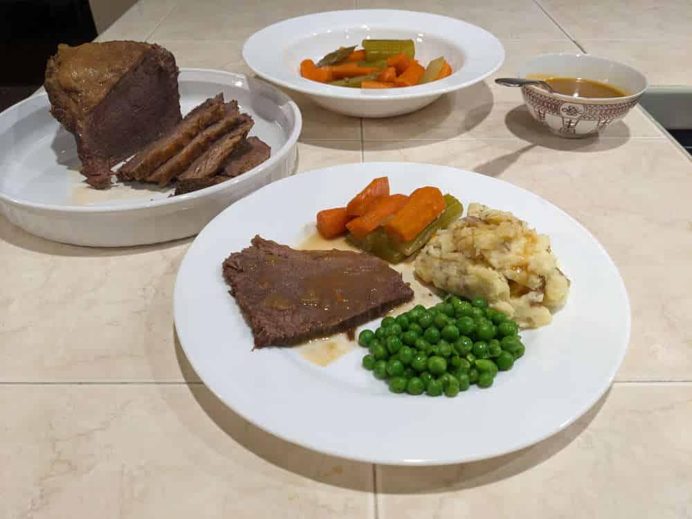 Dish of Pot Roast With Celery, Carrots, Mashed Potato and Peas